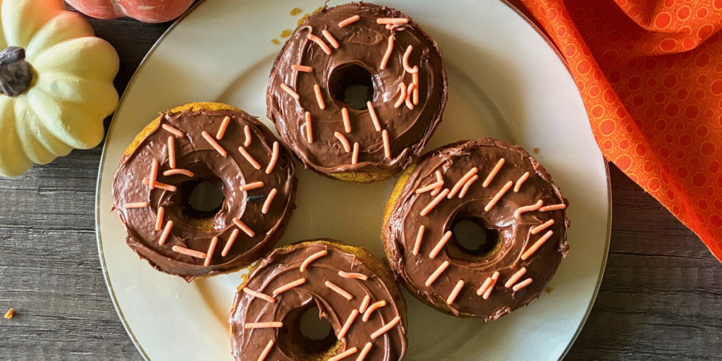 Baked Pumpkin Donuts with Hazelnut Spread are moist and tender, perfectly spiced, and topped with sweet, creamy hazelnut spread delivering the warm, cozy flavors of fall in every bite.