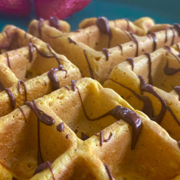 Pumpkin spice waffles drizzled with dark chocolate.