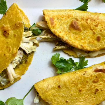 Loaded with fresh pesto, shredded chicken, spinach, gooey mozzarella cheese, all sandwiched between a crispy, crunchy baked corn tortilla