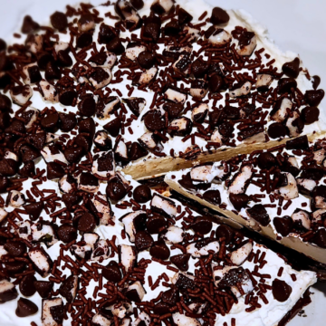 Super Minty Ice Cream Cake with Oreo Crust has vanilla ice cream with mint, fudge, whipped cream and peppermint patties