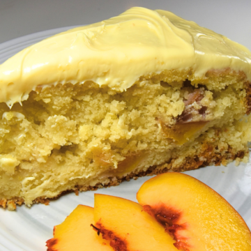 Light and fluffy vanilla cake with sweetened peaches and topped with buttercream frosting