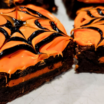 Fudgy brownies with a Halloween oreo filling and spiderweb frosting