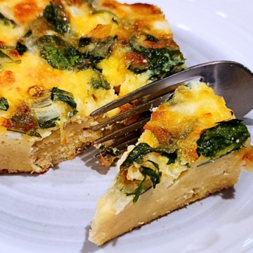 Rustic Bread Breakfast Bake has layers of buttery cubes French bread with cheddar, spinach, onions, and a savory egg custard for an irresistibly cheesy, golden casserole that’s perfect for lazy mornings or feeding a hungry crowd.