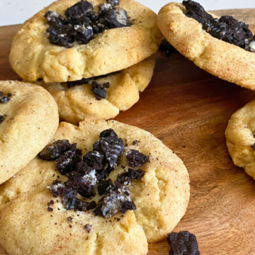 These Oreo Crunch Snickerdoodle Cookies are super thick and chewy, with a buttery, slightly tangy flavor, topped with pieces of crunchy Oreo cookie crumbs and rolled in a cinnamon-flavored sugar coating.