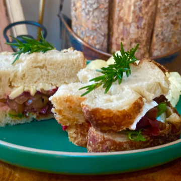 Turkey, bacon, brie cheese, cranberry sauce and balsamic onion jam is stacked high on fresh bread to create this Turkey Brie Winter Club.