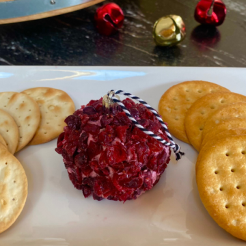 This Cranberry Jalapeño Cheese Ball is the perfect holiday appetizer. It's packed with holidays flavors and shaped into a festive ornament.