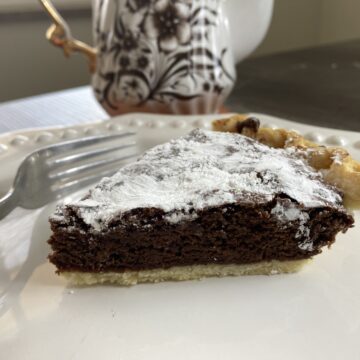 Buttery crust with a rich, chewy brownie center and a crispy powdered sugar topping