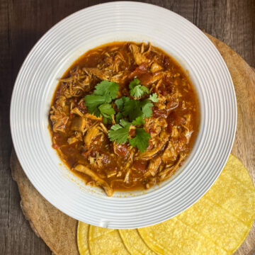 Spicy Chipotle Crockpot Chicken is slow-cooked until the chicken is super tender and absorbs all of the flavors of the sauce. Made with spicy chipotle adobo peppers, fire-roasted tomatoes, and green salsa verde, it's satisfying and delicious