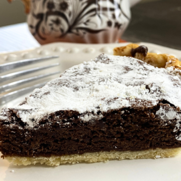 Buttery crust with a rich, chewy brownie center and a crispy powdered sugar topping