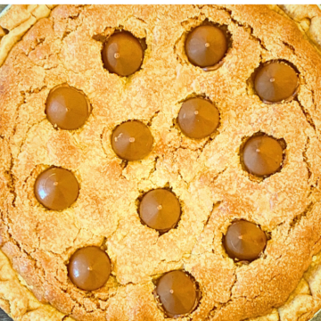 Buttery, Flaky pie crust filled with peanut butter cookie and topped with milk chocolate kisses