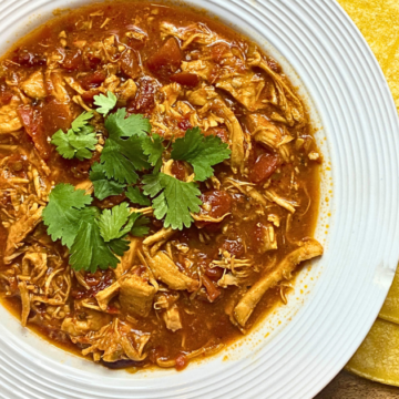 Spicy Chipotle Crockpot Chicken is slow-cooked until the chicken is super tender and absorbs all of the flavors of the sauce. Made with spicy chipotle adobo peppers, fire-roasted tomatoes, and green salsa verde, it's satisfying and delicious