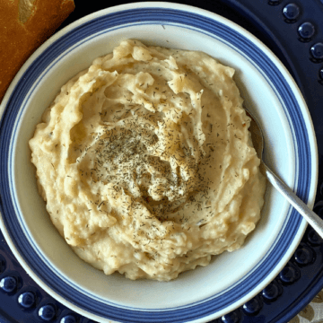 With tender potatoes simmered in a rich, creamy broth with two kinds of cheese and herbs like basil, oregano, and thyme, Easy Creamy Crockpot Potato Soup is the ultimate cozy comfort meal.