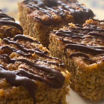 Healthy Banana Applesauce Snacking Cake is light, fluffy, full of bananas, with a light chocolate drizzle.