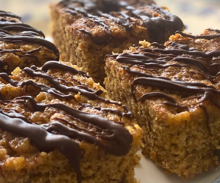 Healthy Banana Applesauce Snacking Cake is light, fluffy, full of bananas, with a light chocolate drizzle.