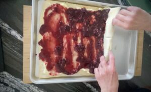Roll the dough starting with the shorter end of the rectangle.