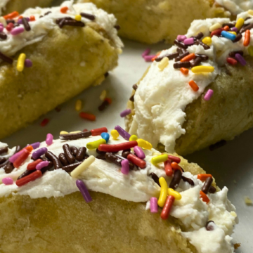 Light, fluffy banana sponge cake is filled with creamy vanilla frosting and topped with rainbow sprinkles