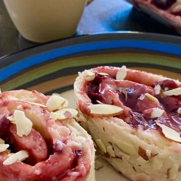 Shortcut cherry almond breakfast pastry is stuffed with sweet cream cheese and cherry jam and drizzled with almond glaze and almond slivers.