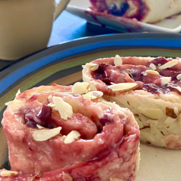 Shortcut cherry almond breakfast pastry is stuffed with sweet cream cheese and cherry jam and drizzled with almond glaze and almond slivers.