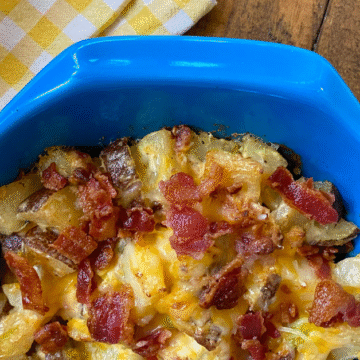 Warm Loaded Baked Potato Salad has a creamy bacon sour cream dressing and all of your favorite loaded baked potato topping mixes right in.