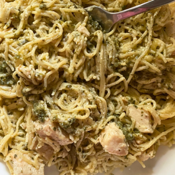 Spaghetti noodles are tossed in a cream cheese and pesto sauce, topped with mozzarella cheese and baked until bubbly and golden brown, for the perfect warm, satisfying meal.