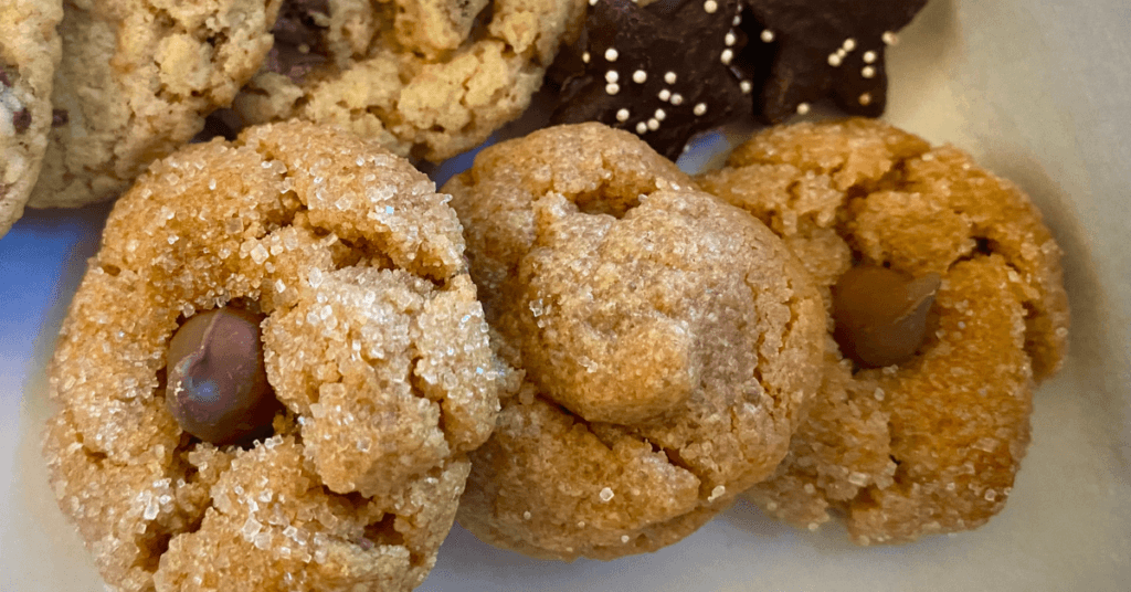 Peanut butter cookies rolled in sugar and topped with a single chocolate chip.