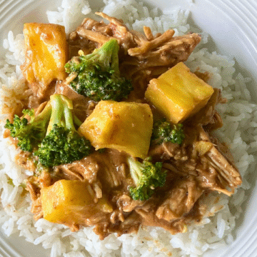 Shredded chicken in a thick creamy coconut ginger peanut sauce, with broccoli and pineapple, Crockpot Coconut Peanut Chicken is an easy and satisfying meal any night of the week!