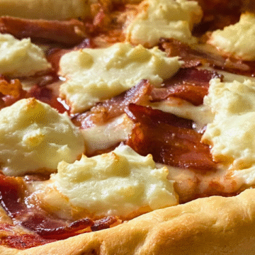 Thick chewy crust, layers of mozzarella and smooth cream cheese, and topped with with crispy bacon pieces