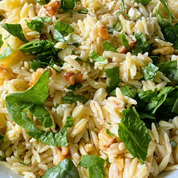 Walnut Spinach Feta Orzo Pasta Salad brings together warm, tender orzo tossed in a bright honey-Dijon rice vinegar dressing with crunchy toasted walnuts, crumbly feta crumbles, and fresh spinach