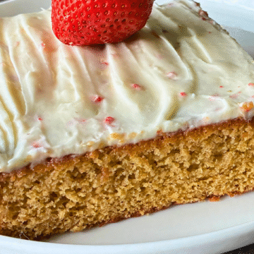Copycat Trader Joes Strawberry Sheet Cake is soft and light, with a sweet layer of strawberry jam to give it a subtle strawberry flavor, then topped with a smooth, classic cream cheese frosting speckled with freeze-dried berries.