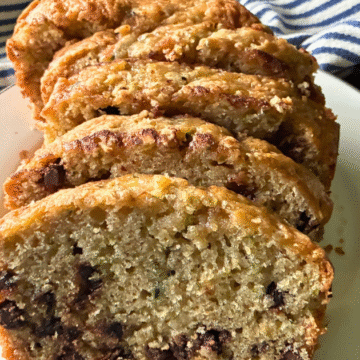 This Simple Zucchini Chocolate Chip Loaf is super moist and fluffy, with a slightly crispy, crackly top, and loaded with chocolate chips!