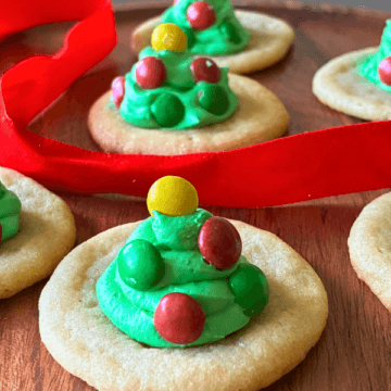 Little Frosted Tree Cookies are an easy holiday sugar cookie you can make with kids using store-bought sugar cookie dough and canned frosting.