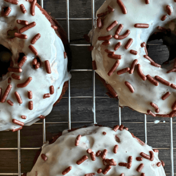These Glazed Dark Chocolate Baked Donuts have everything you love about an old-fashioned cake donut—rich cocoa flavor, a tender crumb, melty pockets of chocolate, and a light vanilla glaze finished with festive sprinkles.
