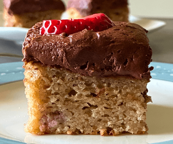 A soft, moist gluten-free strawberry cake packed with fresh strawberries and topped with a smooth, creamy chocolate frosting