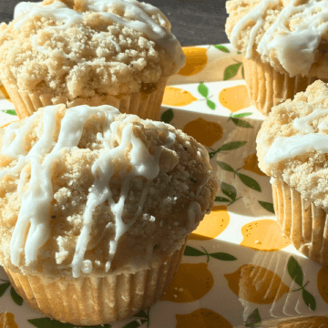 These gluten free lemon poppy seed muffins are soft, fluffy, and full of bright lemon flavor in every bite. They have that classic bakery-style look—tall tops, a buttery crumb topping, and a light lemon glaze that pulls everything together.