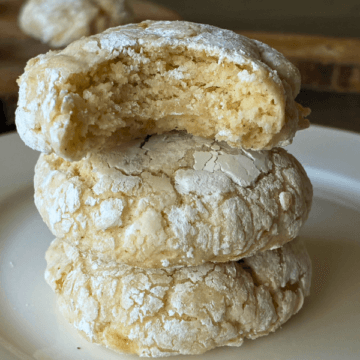 Gooey Banana Butter Cookies (gluten free) are Soft and pillowy with sweet banana pockets and that signature crackly powdered sugar coating. Think banana bread meets a gooey butter cookie—rich, tender, and completely irresistible.